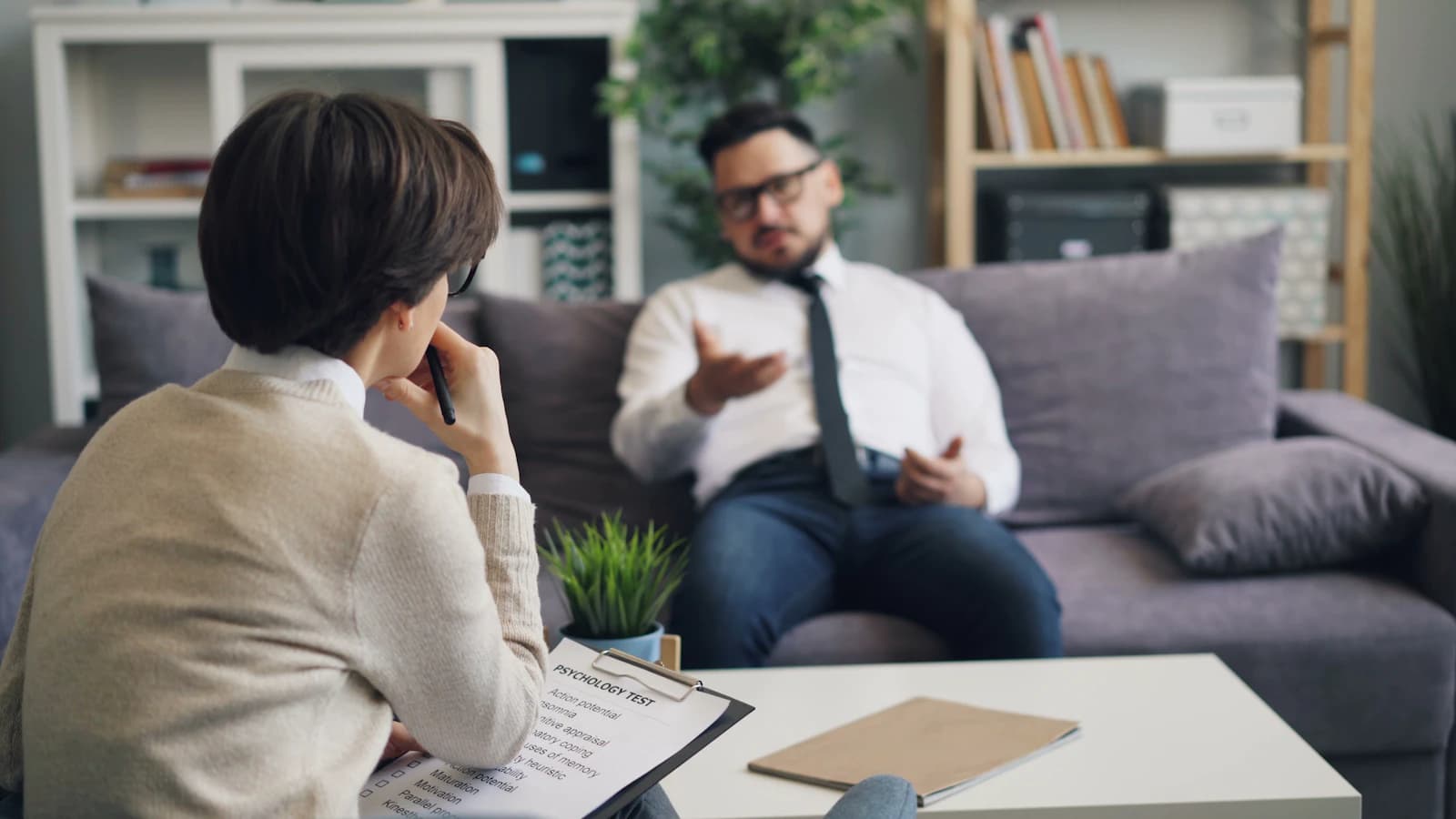 A counsellor taking notes during a session